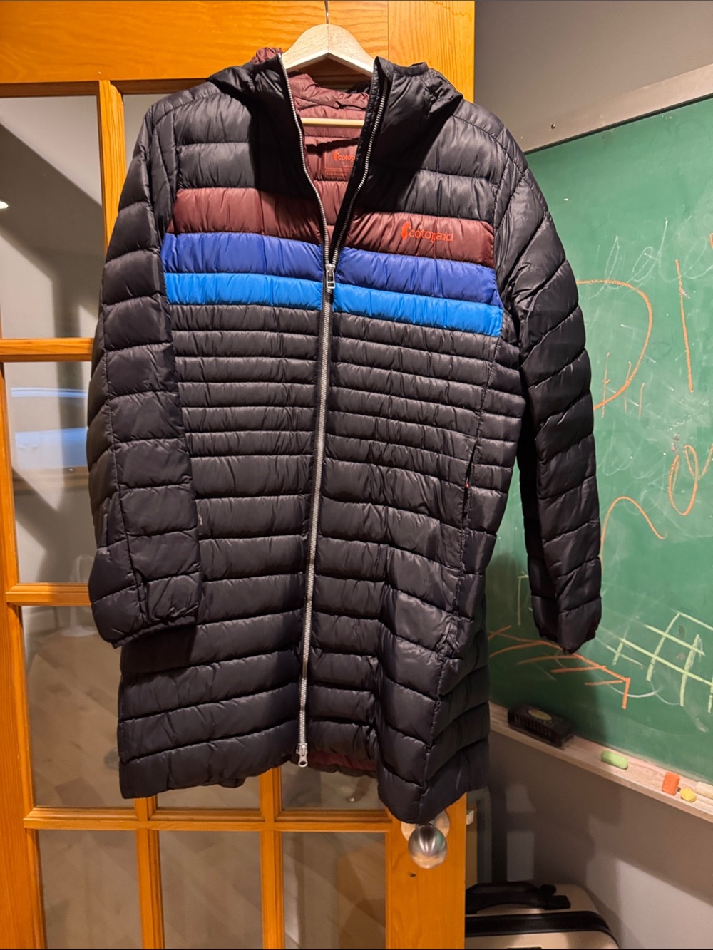 Women’s size medium Cotopaxi thin Puffer Coat with Blue & Brown Chest Stripes